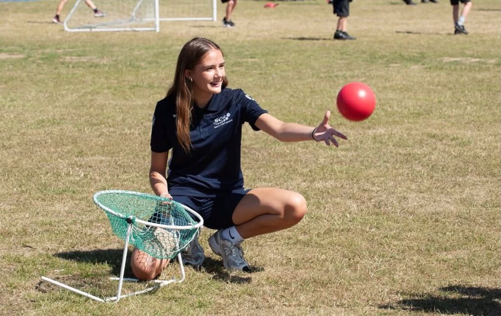 Maia helping young people develop confidence through community sport by leading a sports session